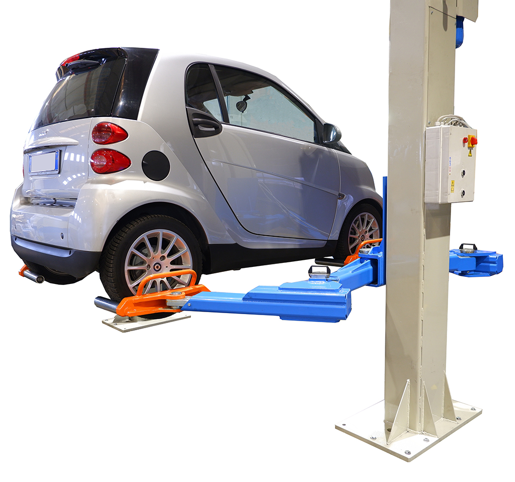 a small electric car lifted by an OMCN car lift for garages